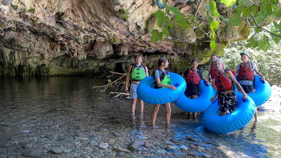 Children floating in cave 